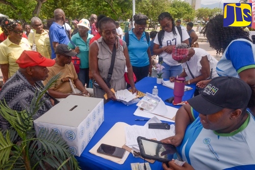 Seniors register at the National Council for Senior Citizens (NCSC) booth, during an Ageing Fair held at Emancipation Park in St. Andrew on Thursday (Sept. 11).