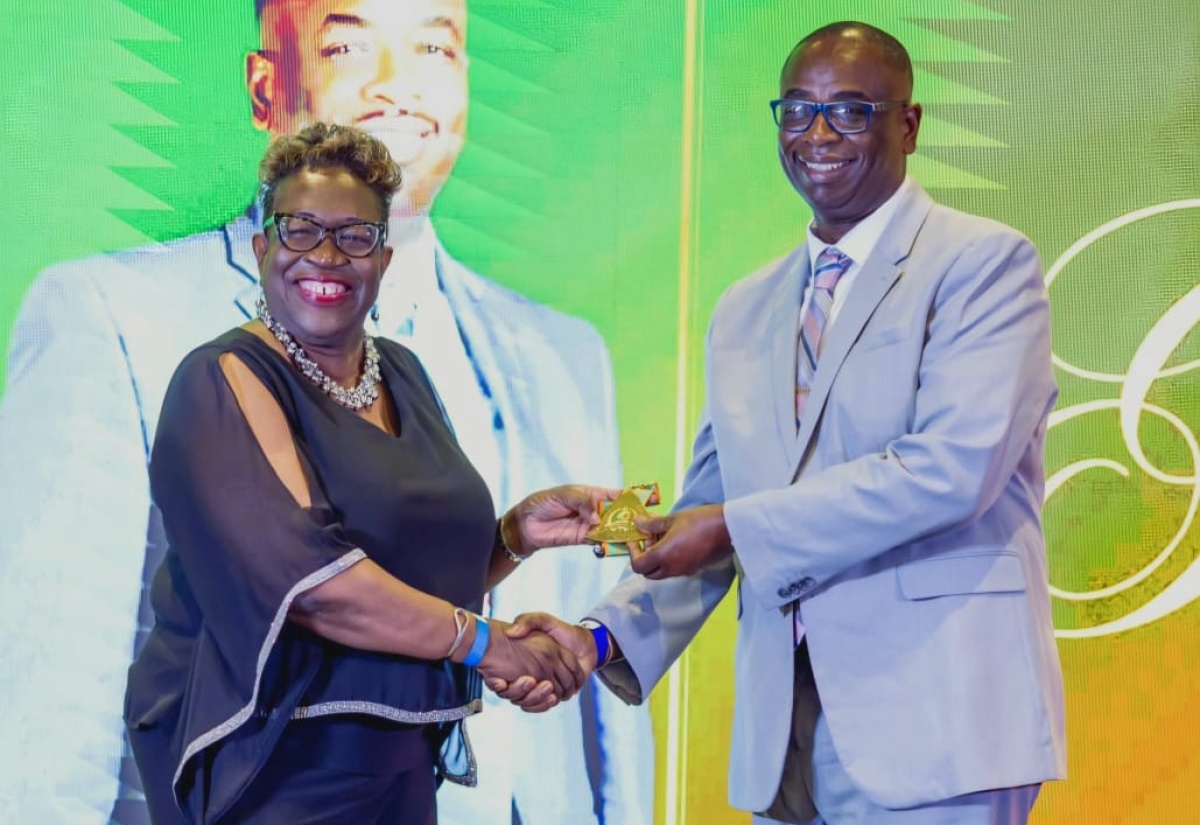 Director of Public Prosecutions (DPP), Paula Llewellyn (left), presents a plaque to Principal of the Manchester-based Church Teachers’ College, Dr. Garth Anderson, for his Diamond Legacy Award for Excellent Service, during the institution’s 60th anniversary and gala awards ceremony, held recently at The Jamaica Pegasus hotel in New Kingston.

