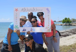 Manager, Natural Resource Management and Environment Planning (NRMEP), Urban Development Corporation (UDC), Sean Townsend (left), with (from second left): Chief Executive Officer/Government Town Planner, National Environmental and Planning Agency (NEPA), Leonard Francis; Director of NRMEP, Sara Simpson; Environmental Coordinator, Loriann Harris and Manager, Ecosystems Management Branch, NEPA, Monique Curtis (front), after they removed several bags of garbage from the Hellshire Bay Beach, in St. Catherine, on September 21, to commemorate International Coastal Cleanup Day 2025.

