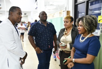 Minister of Education, Skills, Youth and Information, Senator Dr. the Hon. Dana Morris Dixon (right), engages with Medical Chief of Staff at the University Hospital of the West Indies (UHWI), Dr. Carl Bruce (left), at the Accident and Emergency Unit where 21 individuals injured in Tuesday’s bus crash in Dublin Castle, St. Andrew East Rural, were treated. She is accompanied by Parliamentary Secretary in the Ministry of Education, Senator Marlon Morgan, and State Minister in the Ministry of Health and Wellness, Hon. Krystal Lee. Among the injured were 18 students from Louise Bennett-Coverley Primary School and St Martin de Porres Primary School.


