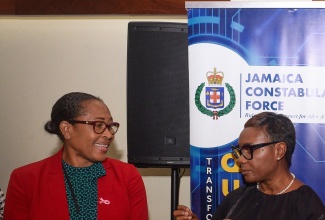 Minister of State in the Ministry of National Security, Hon. Juliet Cuthbert Flynn (right), converses with Assistant Commissioner of Police, Community Safety and Security Branch, Charmaine Shand, during a recent engagement in Kingston.