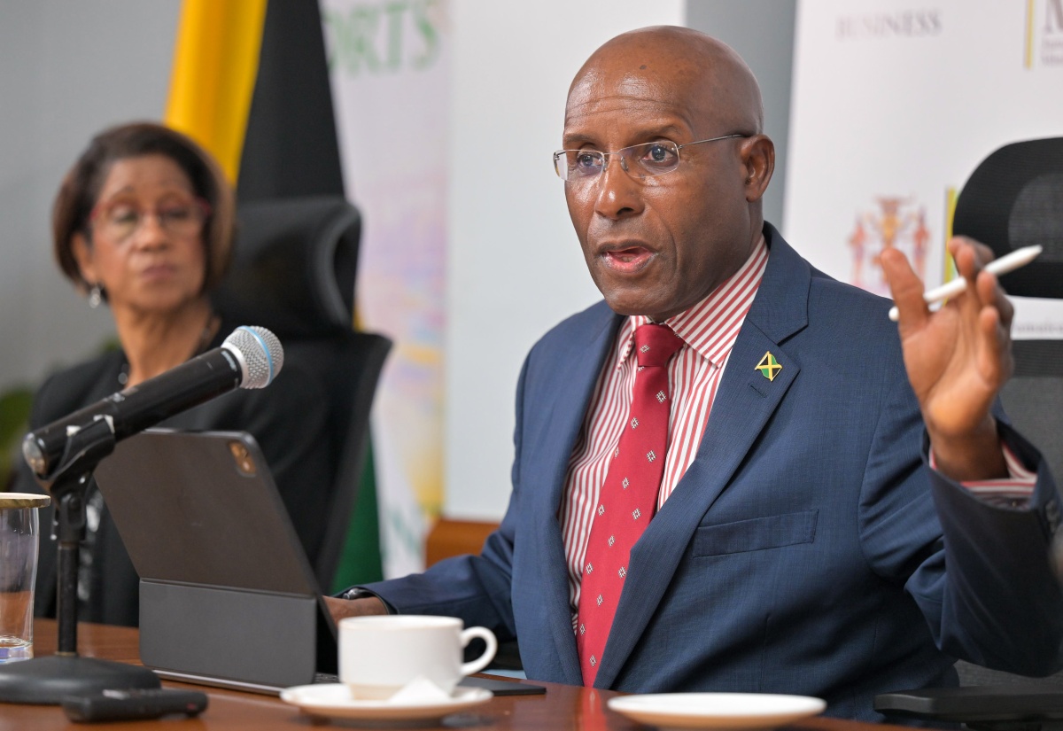 Minister of Industry, Investment and Commerce, Senator the Hon. Aubyn Hill,  speaks with reporters during a press conference at the Ministry’s New Kingston office on Tuesday (September 23), to provide an update on matters related to the Companies Office of Jamaica (COJ). He is joined by his Permanent Secretary, Sancia Bennett Templer .