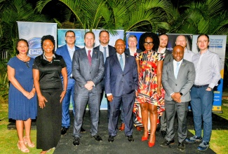 Minister of Industry, Investment and Commerce, Senator the Hon. Aubyn Hill (centre, front row), and Deputy British High Commissioner to Jamaica, Jonathan Cook (second left, front row), share the lens with members of the visiting United Kingdom (UK) Trade Mission to Jamaica, during a welcome reception at the British High Commission in Kingston on Wednesday (October 8).
