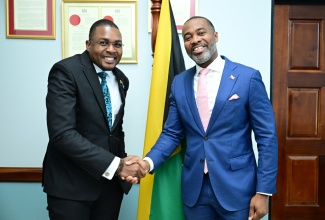 Minister without Portfolio in the Ministry of Economic Growth and Infrastructure Development with Responsibility for Works, Hon. Robert Morgan (left), greets Premier of Bermuda, Hon. E. David Burt, during a courtesy call on Tuesday (October 14). The meeting was held in the Minister’s Courtesy Lounge, located at the National Works Agency (NWA) Corporate Office on Maxfield Avenue in Kingston.

