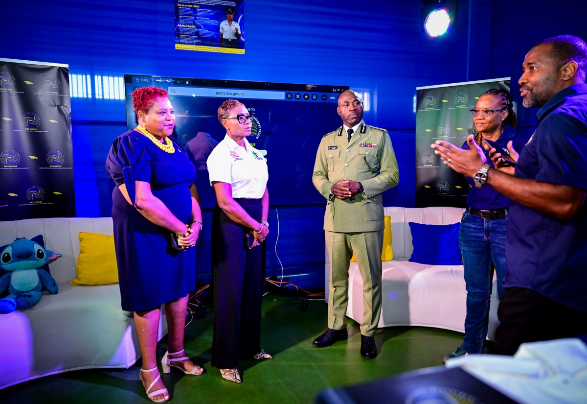 Minister of State in the Ministry of National Security and Peace, Hon. Juliet Cuthbert-Flynn (second left), listens to Director, Management Information System (MIS), Department of Correctional Services (DCS), Leighton Kildare (right), as he explains features of the system during the opening ceremony of the DCS Corrections Expo and Recruitment Drive at the National Arena, on October 17. Others listening (from left) are Chief Technical Director in the Ministry, Shauna Trowers; Commissioner of Corrections, Brigadier (Ret’d) Radgh Mason; and Project Management Lead, Nexus Correctional, Nadria Brown.