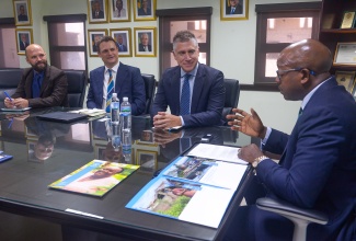 Minister of Labour and Social Security, Hon. Pearnel Charles Jr. (right), is in discussion with (from left) Cash Transfers Officer World Food Programme (WFP), Lorenzo Nerantzis; Deputy Country Director for the WFP Caribbean Multi-Country Office, Daniel Longhurst; and Head of the WFP Jamaica Satellite Office, Dana Sacchetti. Occasion was a courtesy call the WFP team at the Ministry’s offices, 1F North Street office in Kingston on October 15.

