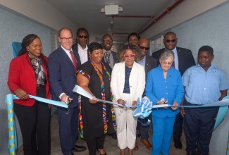 Minister of Education, Skills, Youth and Information, Senator Dr. the Hon. Dana Morris Dixon (front row, fourth left), is joined by (from left) Permanent Secretary, Dr. Kasan Troupe; President and Chief Executive Officer of Christel House International, David Harris; Chief Executive Officer of Christel House Jamaica, Taneshia Stoney Dryden; Co-Founder of Christel House Jamaica, Hon. Sally Porteous; and student, Shavary McFarlane, in the ribbon-cutting ceremony to officially open the high-school building at Christel House Jamaica in Twickenham Park, St. Catherine, on Tuesday (October 7). Observing in the second row (from left) are Councillor for the Spanish Town Division, Christopher Shackleford; Principal, Jason Scott; Acting Chief Education Officer, Terry-Ann Thomas-Gayle; Board Chairman, Hon. Steadman Fuller; and Parliamentary Secretary in the Education Ministry, Senator Marlon Morgan.

