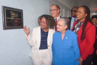 Minister of Education, Skills, Youth and Information, Senator Dr. the Hon. Dana Morris Dixon (left), and Co-Founder of Christel House Jamaica, Hon. Sally Porteous (right), read the dedication plaque during Christel House Jamaica’s anniversary and ribbon-cutting ceremony held on Tuesday, October 7, at the institution in Twickenham Park, St. Catherine. Also pictured are (back row, from left) President and Chief Executive Officer of Christel House International, David Harris; Parliamentary Secretary in the Education Ministry, Senator Marlon Morgan, and Permanent Secretary, Dr. Kasan Troupe; and Chief Executive Officer of Christel House Jamaica, Taneshia Stoney Dryden.

