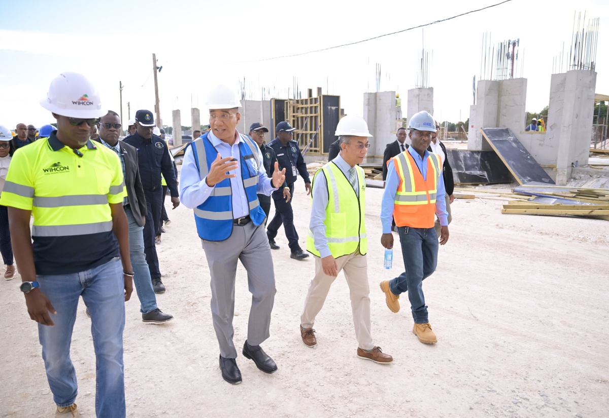 Prime Minister, Dr. the Most Hon. Andrew Holness (second left), converses with Construction Manager at West Indies Home Contractors Limited (WIHCON), Patrick Turner (left), during a tour of the construction site of the Jamaica Constabulary Force  (JCF) St. Catherine North Divisional Headquarters in Spanish Town, on Wednesday (October 8). They are joined by Deputy Prime Minister and Minister of National Security and Peace, Hon. Dr. Horace Chang (second right); and Chief Technical Director, Security Risk Reform and Transformation Policy Division in the Ministry of National Security and Peace, Delroy Simpson. The project is undertaken at a cost of $2.3 billion and is being funded through the Government’s Capital Expenditure (CAPEX) Programme.

