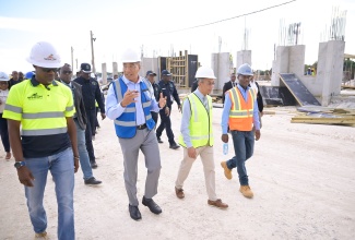 Prime Minister, Dr. the Most Hon. Andrew Holness (second left), converses with Construction Manager at West Indies Home Contractors Limited (WIHCON), Patrick Turner (left), during a tour of the construction site of the Jamaica Constabulary Force  (JCF) St. Catherine North Divisional Headquarters in Spanish Town, on Wednesday (October 8). They are joined by Deputy Prime Minister and Minister of National Security and Peace, Hon. Dr. Horace Chang (second right); and Chief Technical Director, Security Risk Reform and Transformation Policy Division in the Ministry of National Security and Peace, Delroy Simpson. The project is undertaken at a cost of $2.3 billion and is being funded through the Government’s Capital Expenditure (CAPEX) Programme.

