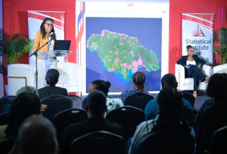 Director of Censuses, Demographic and Social Statistics at the Statistical Institute of Jamaica (STATIN), Stacy-Ann Robinson, addresses STATIN’s Quarterly Press Briefing, held on Wednesday (October 15) at S Hotel in Kingston. At left is STATIN Director General, Leesha Delatie-Budair.