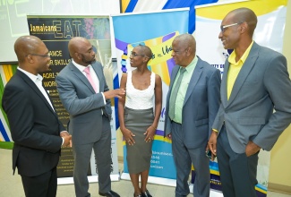 State Minister in the Ministry of Agriculture, Fisheries and Mining, Hon. Franklin Witter (second right), engages in conversation with (from left) President of the University of Technology (UTech), Jamaica, Dr. Kevin Brown; Minister without Portfolio in the Office of the Prime Minister with Responsibility for Science, Technology and Special Projects, Dr. the Hon. Andrew Wheatley; Director of the Jamaican Education AgriTech (EAT) Programme and Technology Competition, Corrinne Martin; and Member of Jamaicans EAT, Dr. Paul Campbell. The occasion was the initiative’s launch on Thursday (October 16) at UTech’s Papine Campus in St. Andrew. The initiative will train and support 94 university students in designing and manufacturing hydroponic systems to help address climate change and strengthen food security in Jamaica.

