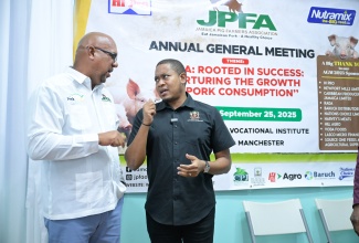 Minister of Agriculture, Fisheries and Mining, Hon. Floyd Green (right), and President of the Jamaica Pig Farmers Association, Hanif Brown, are in discussion, at the Association’s Annual General Meeting held recently at St. John Bosco in Hatfield, Manchester. The event featured discussions on the industry