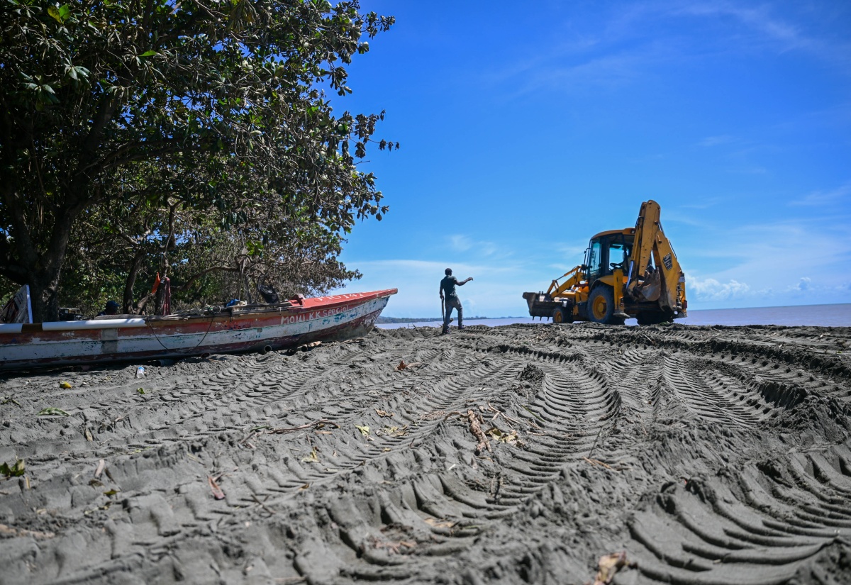 A tractor is used to help clear debris at the Morant Bay Fishing Village in St. Thomas on October 30, following the passage of Hurricane Melissa.