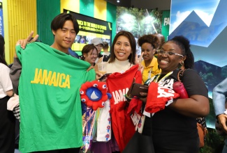 Volunteer at the Jamaica Pavilion at Expo 2025, Osaka, Kansai, Japan, Bridgette Roye (right), shares a light moment with guests during their visit to the Pavilion.

