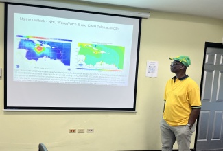 Minister of Local Government and Community Development, Hon. Desmond Mckenzie, looks at the forecast track for Hurricane Melissa during a visit to the National Emergency Operations Centre (NEOC) located at the Office of Disaster Preparedness and Emergency Management (ODPEM) in Kingston on Saturday (Oct. 26).