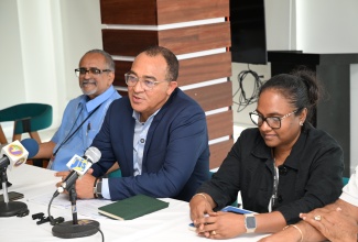 Health and Wellness Minister, Dr. the Hon. Christopher Tufton (centre), addresses a press briefing held at S Hotel in Montego Bay, St. James, on Thursday (October 9). He is joined by Clinical Coordinator at the Western Regional Health Authority (WRHA), Dr. Delroy Fray (left) and Regional Technical Director at the Western Regional Health Authority (WRHA), Dr. Diane Campbell-Stennett.