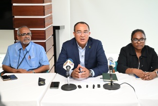  Health and Wellness Minister, Dr. the Hon. Christopher Tufton (centre), addresses a press briefing held at S Hotel in Montego Bay, St. James, on Thursday (October 9). He is joined by Clinical Coordinator at the Western Regional Health Authority (WRHA), Dr. Delroy Fray (left), and Regional Technical Director at the Western Regional Health Authority (WRHA), Dr. Diane Campbell-Stennett.