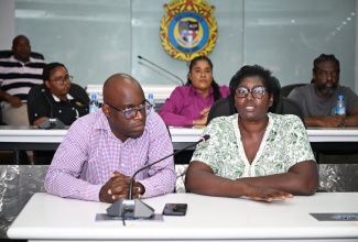 Inspector of Poor for St. James, Pauline Lecky, addresses the Emergency Operations Centre (EOC) meeting at the St. James Municipal Corporation on Thursday (October 23). Looking on is Public Assistance Division (PAD) Administrator at the Ministry of Labour and Social Security, Andrae Earle.

