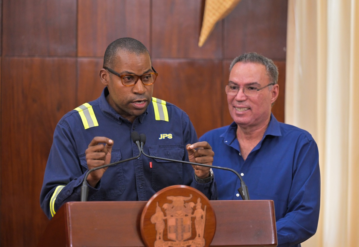 Minister of Energy, Telecommunications and Transportation, Hon. Daryl Vaz (right), listens as Jamaica Public Service Company (JPS) President and Chief Executive Officer, Hugh Grant, outlines the entity’s s operational readiness during a special briefing on Tropical Storm Melissa preparedness, held at Jamaica House on Thursday (October 23).