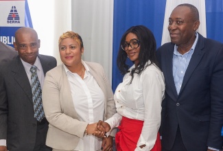 State Minister in the Ministry of Health and Wellness, Hon. Krystal Lee (second left), shakes hands with Jamaican-born philanthropist, Carol Picart (second right), during a medical equipment handover ceremony at the Kingston Public Hospital (KPH) in Kingston on Monday (September 29). The items, valued at $48.7 million, were donated by Ms. Picart in collaboration with the National Healthcare Enhancement Foundation (NHEF) under the Ministry. Sharing the moment are Chief Executive Officer, KPH, Barrington Graham (left) and South Eastern Regional Health Authority (SERHA) Regional Director, Lascelles Brown.

