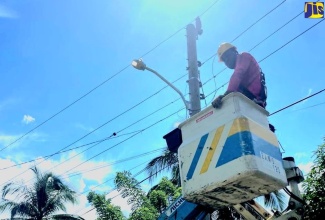 A streetlight being installed in a community in Guy’s Hill, St. Catherine, by contractors from the Jamaica Public Service (JPS) Company.