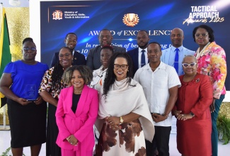 Minister of Education, Skills, Youth and Information, Senator Dr. the Hon. Dana Morris Dixon (front row, left); and Permanent Secretary in the Ministry, Dr. Kasan Troupe (front row, right), share lens time with Principals of National School Learning and Intervention Plan (NSLIP) schools with the highest success rates in mathematics, during the Tactical Approach Awards Ceremony, held at Shortwood Teachers’ College, on Tuesday (October 14). Also with the Principals are Parliamentary Secretary in the Ministry, Senator Marlon Morgan (back row, third right); Acting Chief Education Officer, Terry-Ann Thomas-Gayle (back row, right), and Deputy Chief Education Officer, Winnie Berry (second row, right).