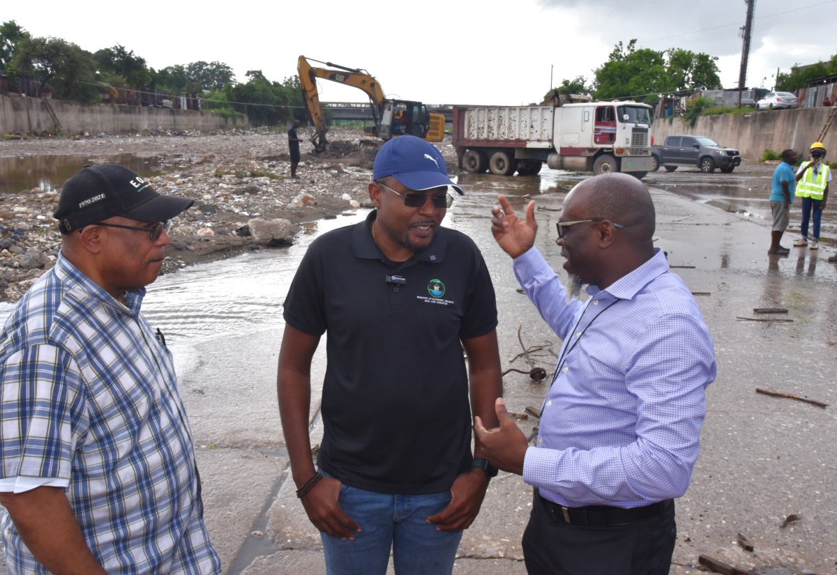 Minister without Portfolio in the Ministry of Economic Growth and Infrastructure Development with Responsibility for Works, Hon. Robert Morgan (centre); Member of Parliament for St. Andrew Western, Anthony Hylton (left); and Communication and Customer Services Manager at the National Works Agency (NWA), Stephen Shaw, confer during a site visit to the Sandy Gully in Kingston on Wednesday (October 22). The visit formed part of ongoing mitigation efforts led by the NWA in anticipation of Tropical Storm Melissa.