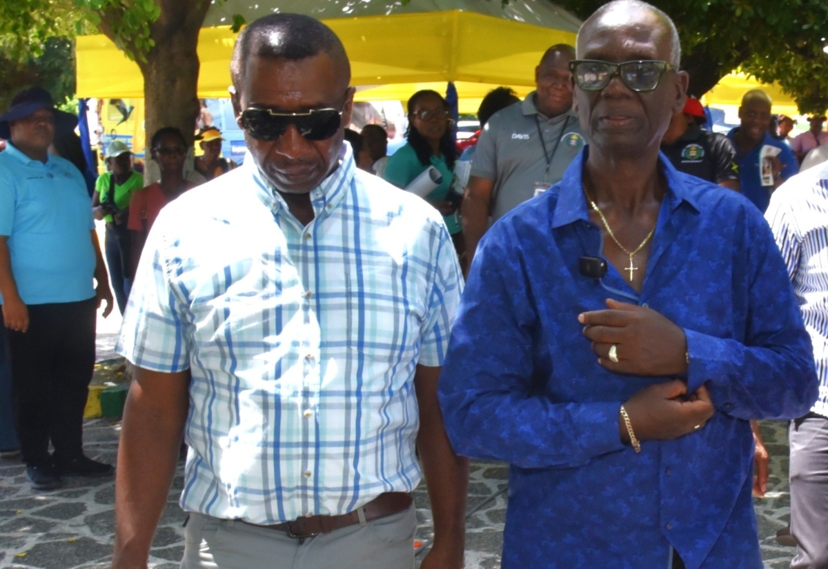 Minister of Local Government and Community Development, Hon. Desmond McKenzie (right) along with Mayor of Kingston, Councillor Andrew Swaby , walk through sections of the Kingston and St. Andrew Municipal Corporation (KSAMC) Wellness in the Park event, held on World Homeless Day, October 10, at the St. William Grant Park in downtown Kingston. The event was hosted by the KSAMC in partnership with the Ministry of Health and Wellness.