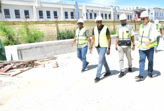 Minister without Portfolio in the Ministry of Economic Growth and Infrastructure Development with responsibility for Works, Hon. Robert Morgan (second left), tours the Bogue leg of the Montego Bay Perimeter Road project in St. James, on Wednesday (October 15). Joining the Minister are (from left) Member of Parliament for St. James Central, Heroy Clarke; Managing Director at the National Road Operating and Constructing Company Limited (NROCC), Stephen Edwards, and Project Manager at China Harbour Engineering Company (CHEC), Hongsheng Gui. 