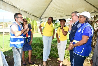Permanent Secretary in the Ministry of Labour and Social Security, Dionne Jennings (right); and Caribbean Country Director, World Food Programme (WFP), Brian Bogart (second right), listen to a comment from Food For the Poor Director in charge of operations and implementation, Nakhle Hado, during a tour of St. Elizabeth on Thursday (October 30). Sharing in the conversation (from second left) are Acting Director for Disaster, Rehabilitation and Welfare Management in the Ministry, Jacqueline Shepherd; Director of Social Security in the Ministry, Suzette Morris; and the Ministry
