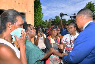 Prime Minister, Dr. the Most Hon. Andrew Holness, consoles family members of the victims of the fatal shooting in Commodore, Linstead, St. Catherine, during a visit to the community on Monday (October 6). Nine people were shot—five fatally, including a four-year-old child—in a brazen gun attack on a family home on Sunday (October 5). The Prime Minister has condemned the act and pledged the Government’s support for the families of the victims.


