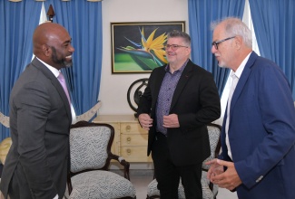 Minister without Portfolio in the Office of the Prime Minister with Responsibility for Science, Technology and Special Projects, Dr. the Hon. Andrew Wheatley (left), interacts with Chairman, Pan Jamaica Group, Stephen Facey (right), and guest speaker for the 2025 Maurice Facey Lecture, Brent Toderian, during a courtesy call at the Office of the Prime Minister on Wednesday (October 8).