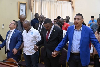 Prime Minister, Dr. the Most Hon. Andrew Holness (right), joins hands in prayer with (from left) Minister of Water, Environment and Climate Change, Hon. Matthew Samuda; Minister of Labour and Social Security, Hon. Pearnel Charles Jr.; and Minister without Portfolio in the Ministry of Economic Growth and Infrastructure Development, with responsibility for Works, Hon. Robert Morgan, during a special press briefing at the Office of the Prime Minister on Friday (October 24). The prayer was led by former chair of the Jamaica Umbrella Groups of Churches (JUGC), Dr. Elaine McCarthy.
