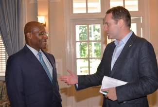 Minister of Industry, Investment and Commerce, Senator the Hon. Aubyn Hill (left), is greeted by Deputy British High Commissioner to Jamaica, Jonathan Cook, during a business briefing and press engagement for the United Kingdon (UK) Trade Mission to Jamaica 2025. The engagement was held at the British High Commission in New Kingston on Wednesday (October 8).