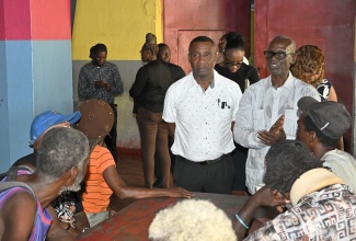Minister of Local Government and Community Development, Hon. Desmond McKenzie (right), and Mayor of Kingston, Councillor Andrew Swaby, engage members of the homeless population in discussion during a stakeholder meeting held on Wednesday (October 15) at the Marie Atkins Night Shelter in downtown Kingston. The session, which included representatives from the Kingston and St Andrew Poor Relief Department, addressed service-related concerns and fostered open dialogue.