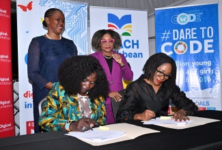 Minister of Education, Skills, Youth and Information, Senator Dr. the Hon. Dana Morris Dixon (right, standing), and Co-Founder of ‘iamtheCODE’ (IATC) Caribbean, Mariéme McIntosh Robinson (left, standing), observe as Founder of the ‘iamtheCODE’ global initiative, Lady Mariéme Jamme (left, seated), and Co-Founder of iamtheCODE Caribbean (IATCC), Nadeen Matthews Blair, sign a Memorandum of Understanding (MOU) to formalise the implementation of a 12-week digital, coding and leadership programme for underserved Jamaican youth. The MOU was signed during the recent (IATCC) press launch at S Hotel in Kingston.

