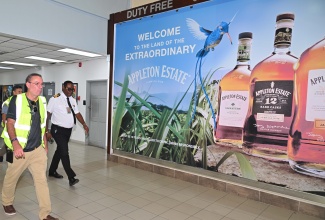Minister of Energy, Telecommunications and Transport, Hon. Daryl Vaz (left), is joined by Director of Customs in charge of the Norman Manley International Airport (NMIA), Devon Manahan, on a tour of the facility on Wednesday (October 29).
