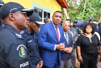 Prime Minister, Dr. the Most Hon. Andrew Holness (left), is flanked by (from left) Commanding Officer for the Jamaica Constabulary Force (JCF) Area Five, Assistant Commissioner of Police (ACP) Christopher Phillips; Police Commissioner, Dr. Kevin Blake; Deputy Prime Minister and Minister of National Security and Peace, Hon. Dr. Horace Chang; and Member of Parliament for St. Catherine North Central, Natalie Neita Garvey, during a visit to the community of Commodore in Linstead, St. Catherine, on Monday (October 6). The visit followed a brazen gun attack on a family home in the community on Sunday (October 5), in which nine people were shot—five fatally, including a four-year-old child. The Prime Minister has condemned the act and pledged the Government’s support for the families of the victims.

