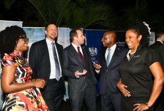 Minister of Industry, Investment and Commerce, Senator the Hon. Aubyn Hill (second, right), enjoys a conversation with Deputy British High Commissioner to Jamaica, Jonathan Cook (centre), at a welcome reception for the United Kingdom (UK) Trade Mission to Jamaica 2025. Sharing in the moment are (from left) Regional Trade Director for the UK