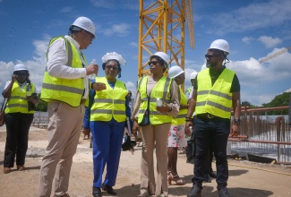 Health and Wellness Minister, Dr. the Hon. Christopher Tufton (left), in discussion with (from second left) Director of Nursing Services at the Spanish Town Hospital, Novellette Robinson; Senior Medical Officer at the Spanish Town Hospital, Dr. Jacqueline Wright- James; and Programme Manager for the Health Systems Strengthening Programme (HSSP), Orett Clarke, during his tour of the Spanish Town Hospital redevelopment project site in St. Catherine, on Wednesday (October 8).

