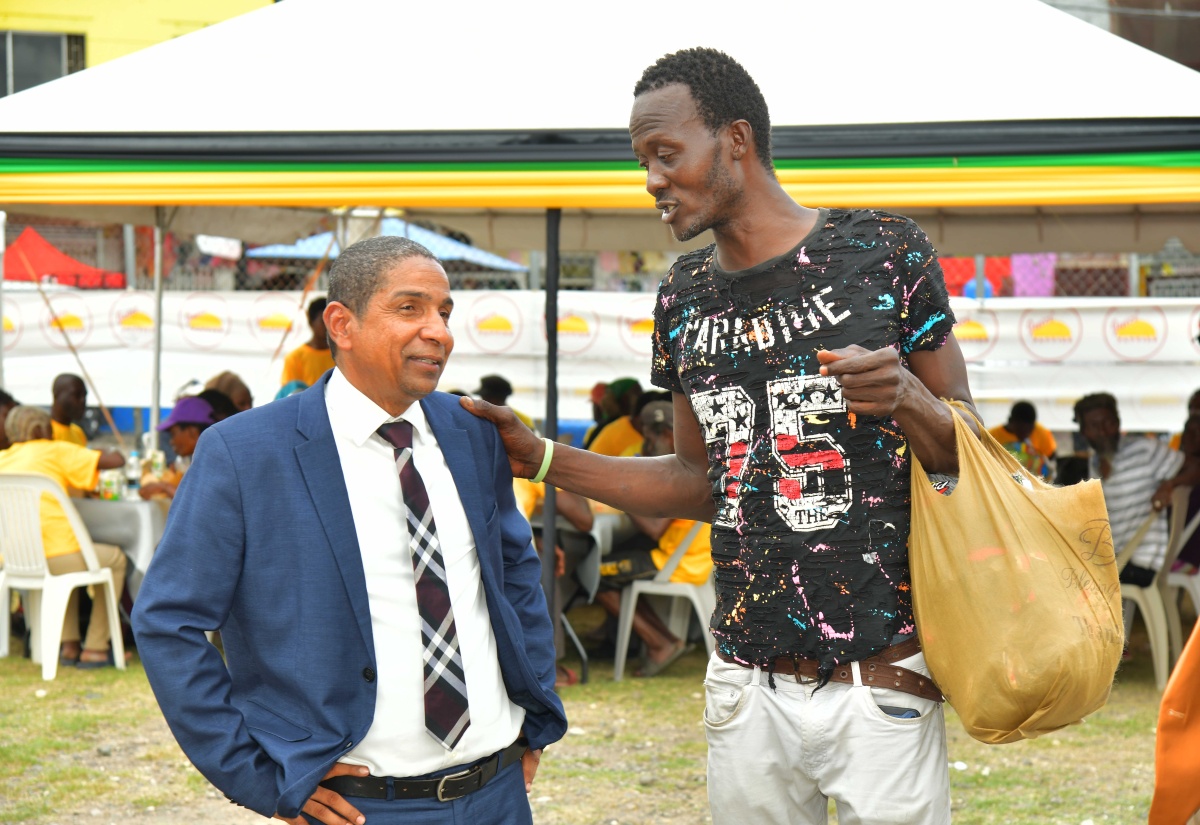 State Minister in the Ministry of Local Government and Community Development, Hon. Delroy Williams (left) engages with Clarendon resident Everton Brown during the Municipal Corporation’s World Homeless Day observance held at the Old Police Station grounds in May Pen, on Friday (October 10).