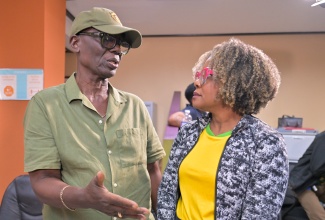 Minister of Local Government and Community Development, Hon. Desmond McKenzie (left), is in discussion with Minister of Education, Skills, Youth and Information, Senator the Hon. Dana Morris Dixon, during a press briefing at the Office of Disaster Preparedness and Emergency Management (ODPEM) in Kingston on Sunday (Oct. 26).