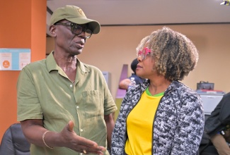 Minister of Local Government and Community Development, Hon. Desmond McKenzie (left), is in discussion with Minister of Education, Skills, Youth and Information, Senator the Hon. Dana Morris Dixon, during a press briefing at the Office of Disaster Preparedness and Emergency Management (ODPEM) in Kingston on Sunday (Oct. 26).