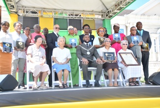 Mayor of Montego Bay, Councillor Richard Vernon (seated, centre) is flanked by citizens honoured during the St. James National Heroes Day Civic and Awards Ceremony held at Sam Sharpe Square in Montego Bay on Monday (Oct. 20).