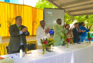 Custos of St. Ann, Hon. Joseph Issa (left), applauds the launch of the St. Ann Custos Commando JP mentorship Initiative, at the Exchange Primary School Auditorium in St. Ann on Tuesday, September 30. Also applauding (from second left) are JP and Coordinator of Mentorship Initiative, Wesley Boynes; Principal of St. John's Preparatory, Bertram Watson; Vice Principal of Exchange Primary, Donna Boreland-Tracey; Exchange Primary School Board Chairman, Gregory Chung and Senior Education Officer of the Guidance Counselling Unit from Region Three, Ministry of Education, Skills, Youth and Information,  Harlene Gordon-Riley.

