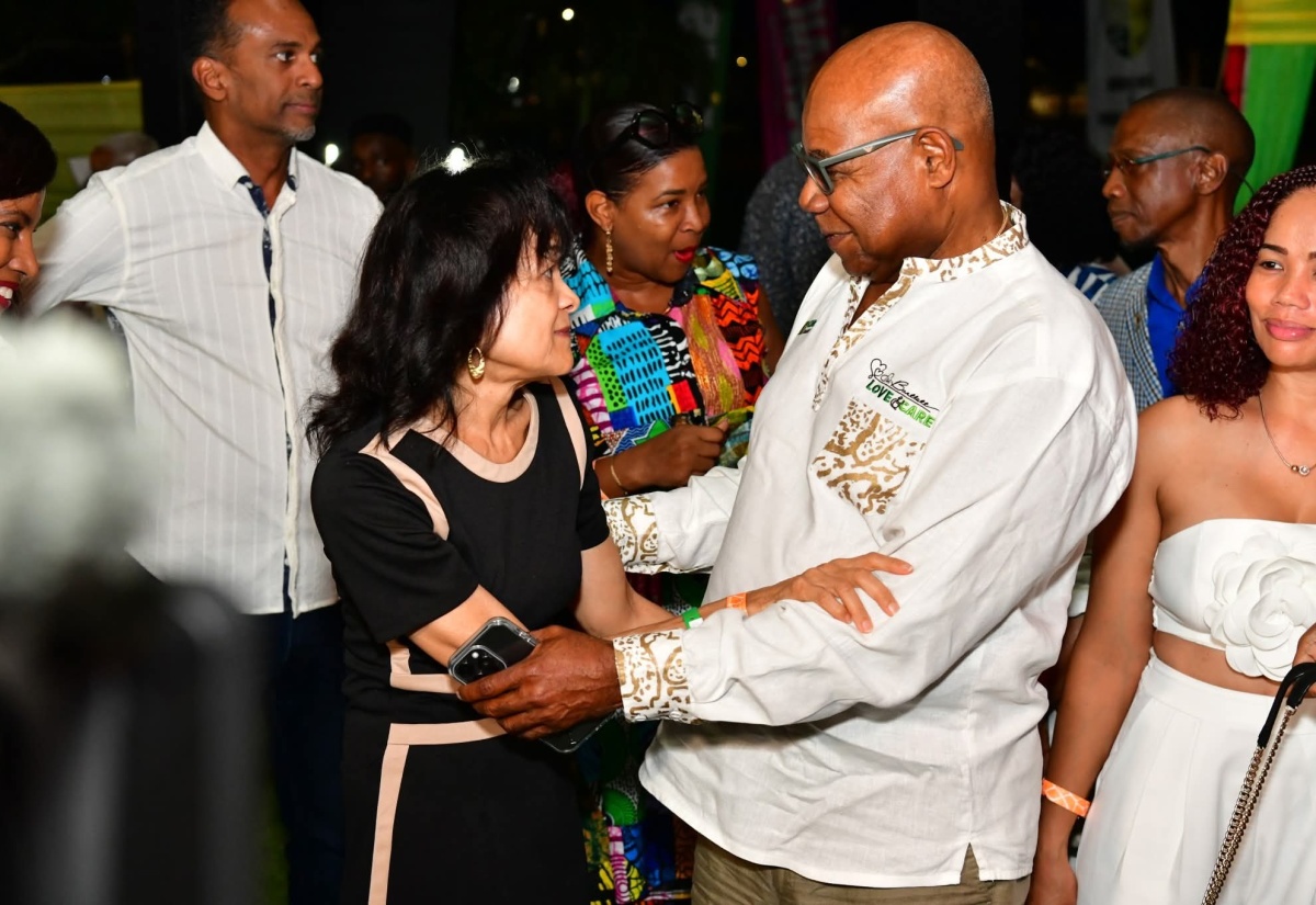 Tourism Minister, Hon. Edmund Bartlett, greets Executive Director of the Jamaica Hotel and Tourist Association (JHTA), Camille Needham, during the 35th staging of the Jamaica Product Exchange (JAPEX) in Montego Bay, St. James.