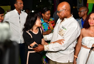 Tourism Minister, Hon. Edmund Bartlett, greets Executive Director of the Jamaica Hotel and Tourist Association (JHTA), Camille Needham, during the 35th staging of the Jamaica Product Exchange (JAPEX) in Montego Bay, St. James.