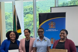 Minister of State in the Ministry of National Security and Peace, Hon. Juliet Cuthbert Flynn (second right) and Resident Representative, Organization of American States (OAS), Office of the General Secretariat in Jamaica, Jeanelle van Glannen Weygel (second left) share a photo opportunity with members of the Jamaica Cyber Incident Response Team (Ja-CIRT), Monique Satchwell (right) and Rheana Hagigal who copped first place in the overall team category of the SheSecures Jamaica Cybersecurity Competition during the award ceremony at the University of the West Indies, Regional headquarters in Mona, Kingston on October 10. 