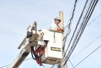 Personnel from the Jamaica Public Service (JPS) Company carry out power restoration work in the vicinity of the 100 Lane community off Red Hills Road in St. Andrew, following the passage of the catastrophic Category 5 Hurricane Melissa.